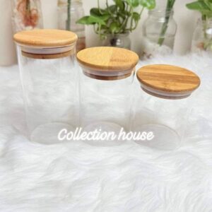 three glass jars with bamboo lids, commonly used for kitchen storage.